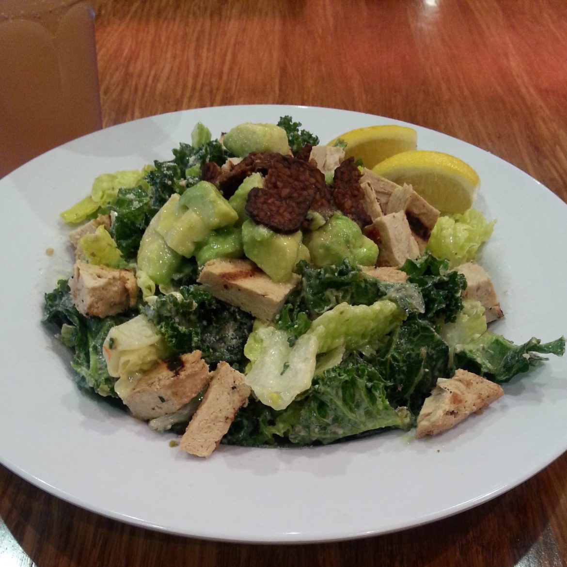 Vegan kale caesar salad with grilled chicken and bacon bits (from Veggie Grill)